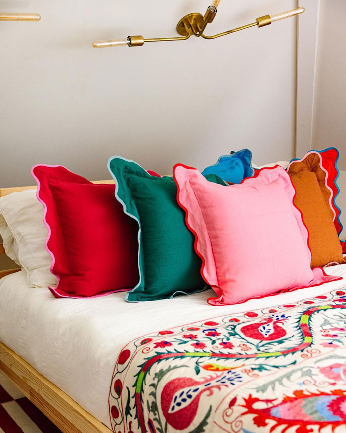 Colorful scalloped pillows on the bed