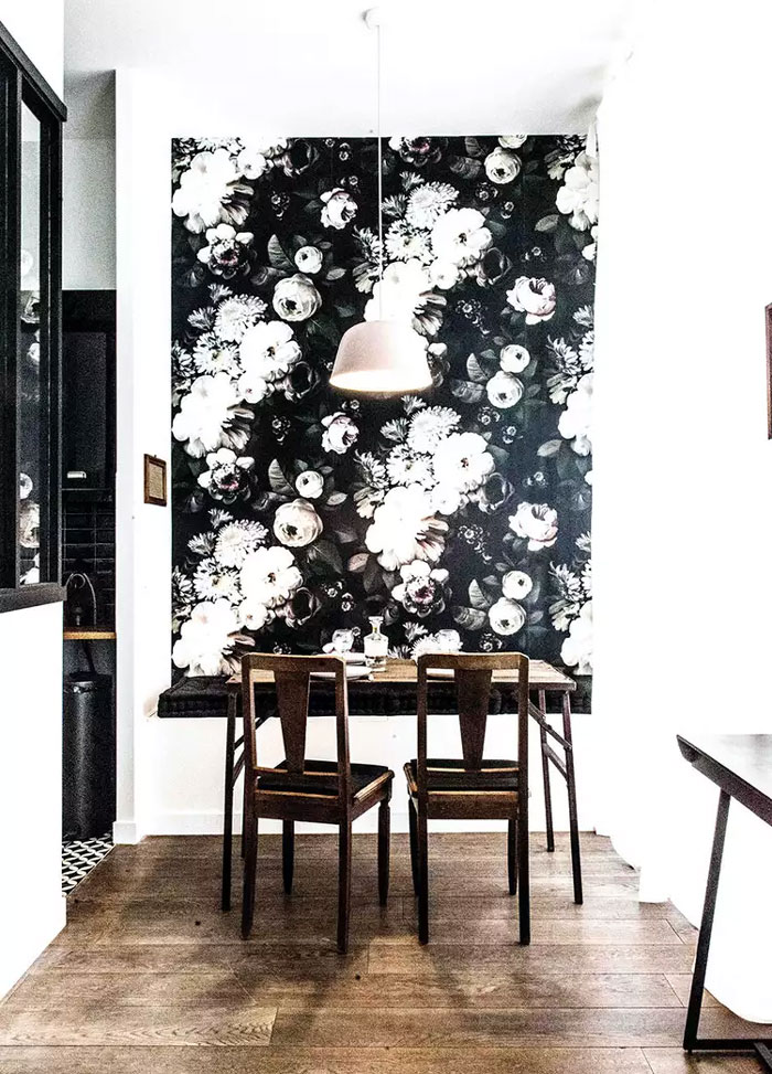 Cozy breakfast nook with a flowery black and white wallpaper