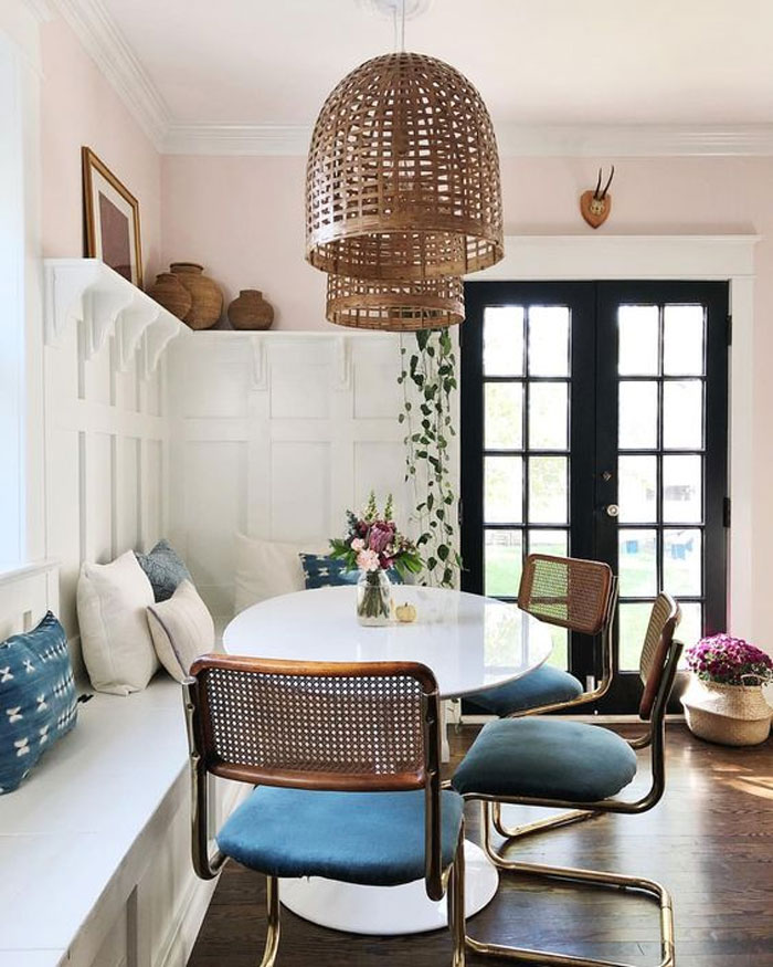 A white round table breakfast nook with blue chairs A white round table breakfast nook with blue chairs