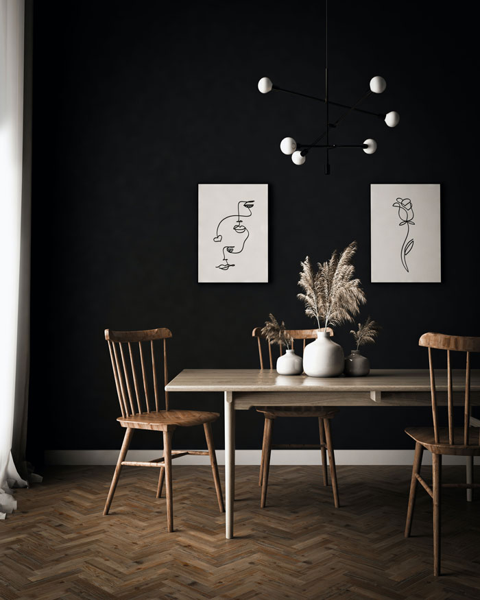 A dark-themed breakfast nook with a dark brown table and chairs