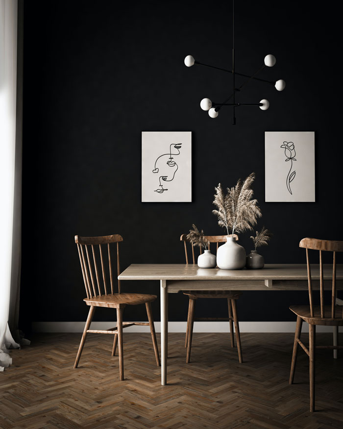 A dark-themed breakfast nook with a dark brown table and chairs A dark-themed breakfast nook with a dark brown table and chairs