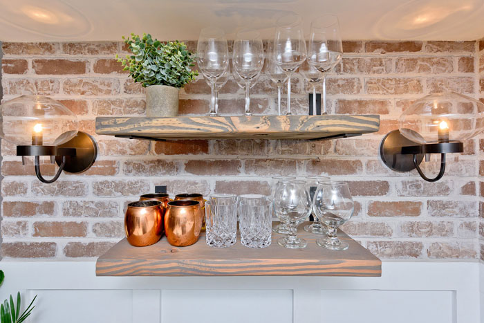 Shelves for glasses on the brick wall