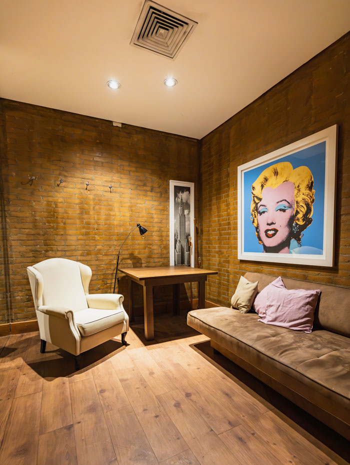Modern brick wall room design with a painting on the wall