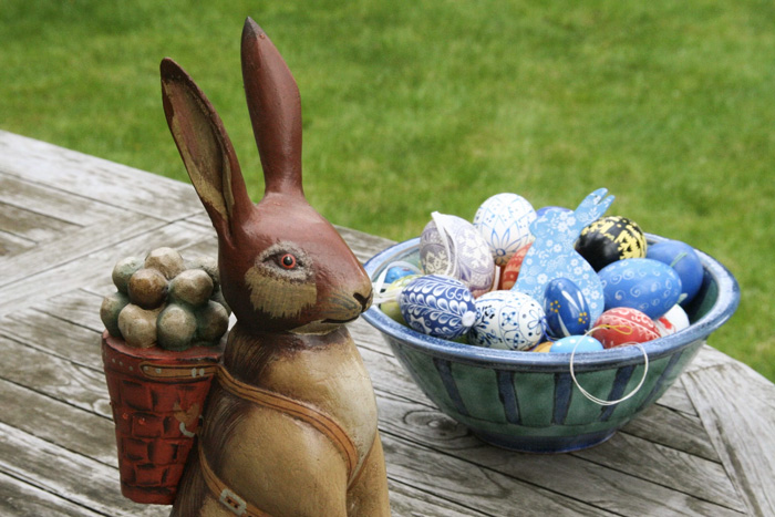 Easter eggs and rabbit figurine placed outside