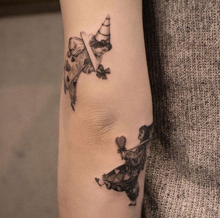 Elegant French Tattoo Above the Elbow