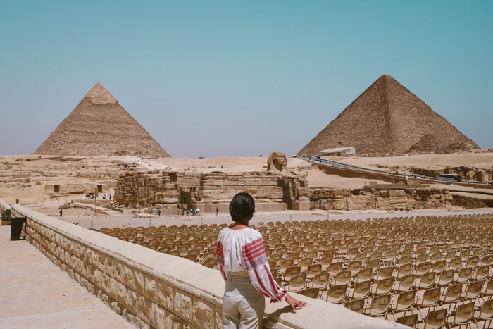 Girl standing in front of two pyramids