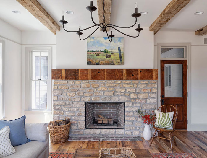 Farmhouse room with bricked fireplace and wooden decor