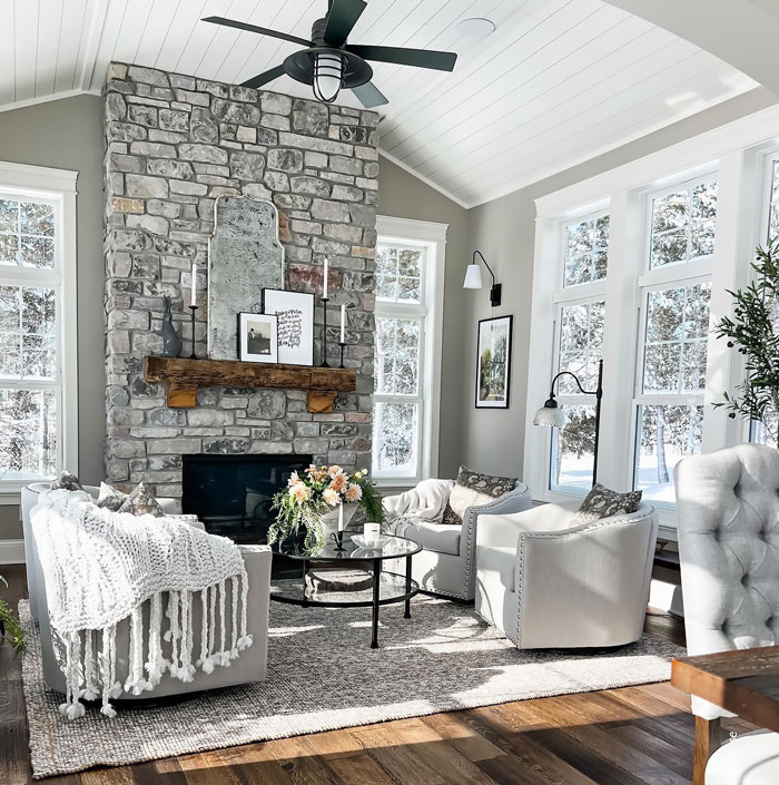 Creamy white farmhouse living room with furniture and wooden floors