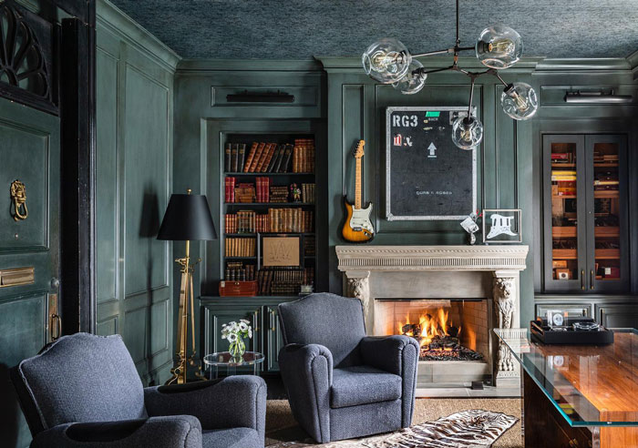 Rustic living room with dark walls fireplace dark furniture