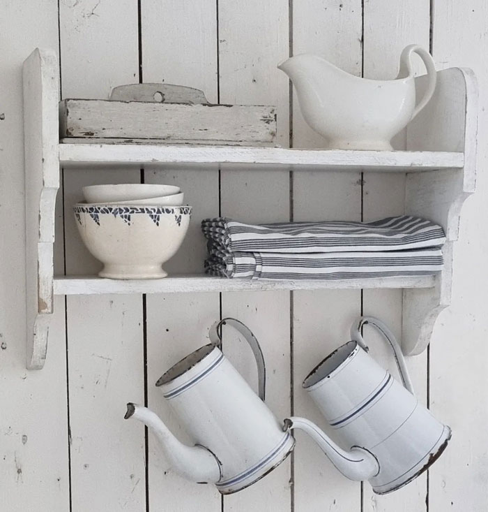 Antique white cupboard with antique dishes
