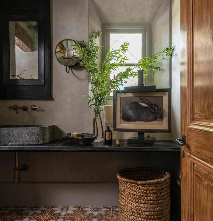 Rustic bathroom with black sink picture of black rabbit basket and flowers