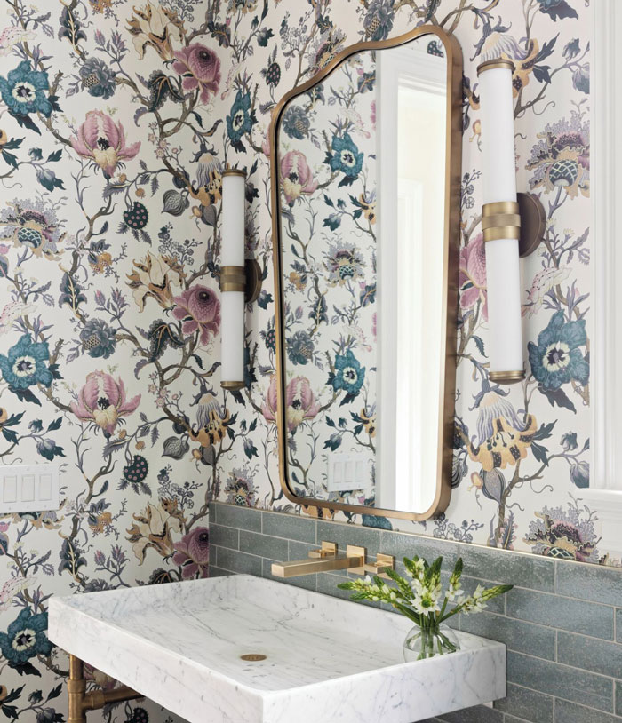Rustic room with flower wallpaper and marble sink with mirror