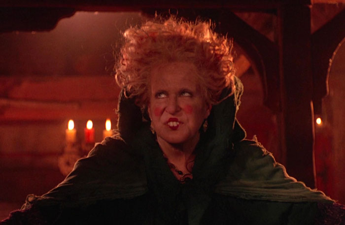 Winifred Sanderson on the red background of candles