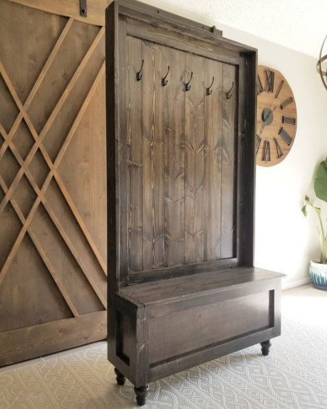 A brown wooden hall tree with a bench A brown wooden hall tree with a bench