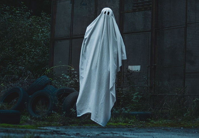 Man wearing ghost costume