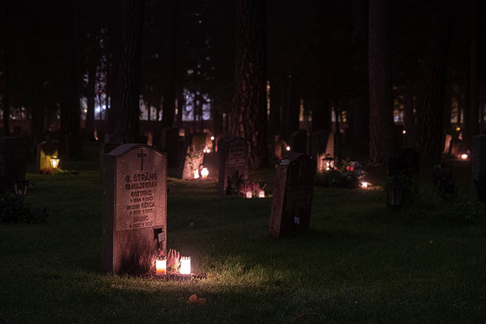 Graveyard at the night with lighted candles