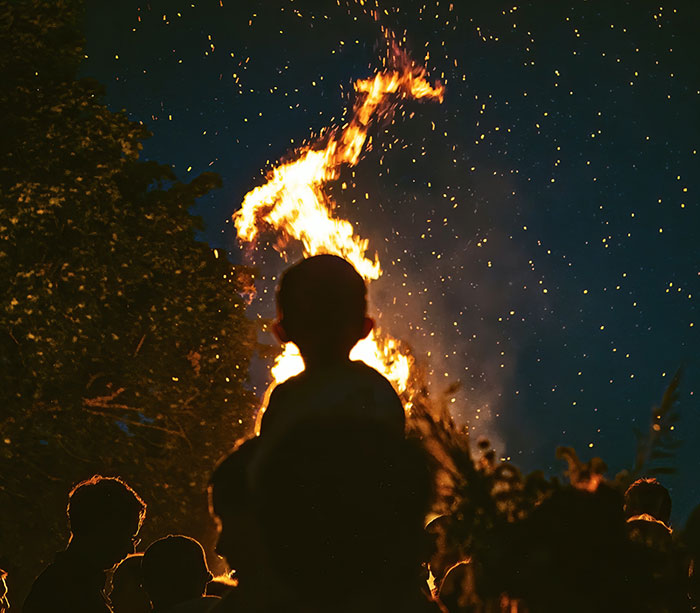 Kids watching bonfire at night