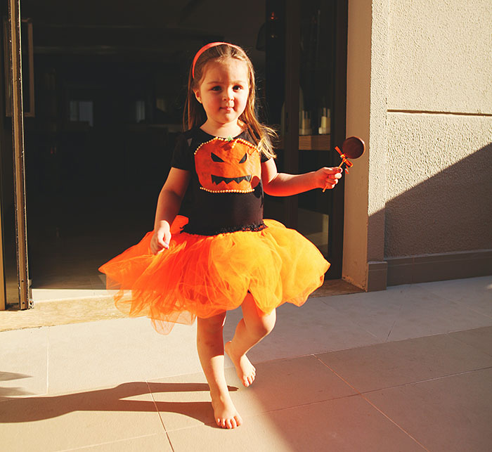 Girl wearing pumpkin costumes