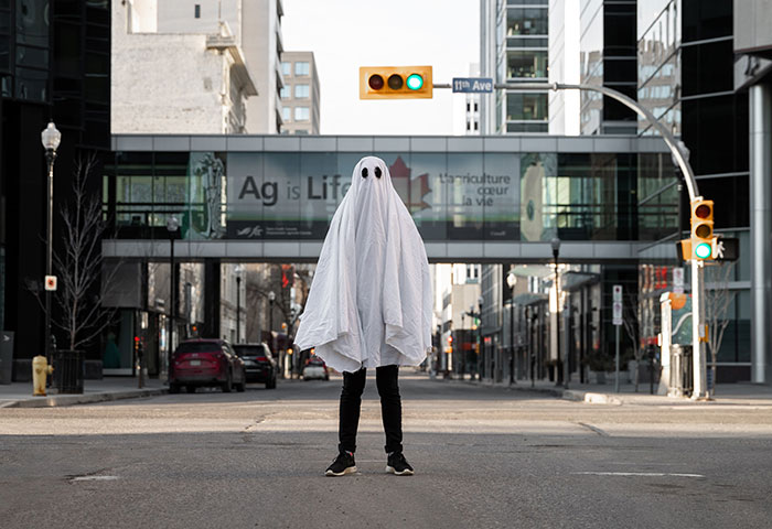 Man wearing ghost costume at street