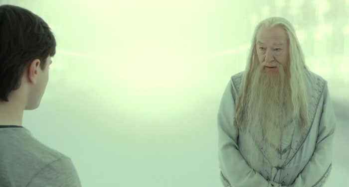 Albus Dumbledore talking something to Harry Potter