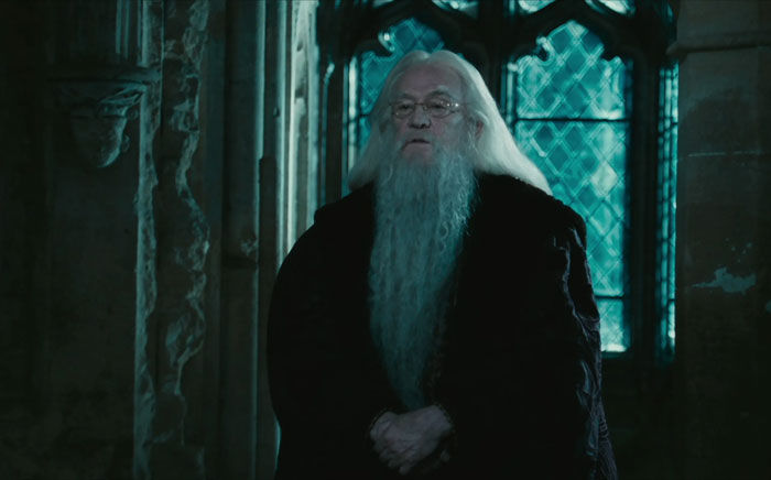  Albus Dumbledore staying near the window with crossed hands