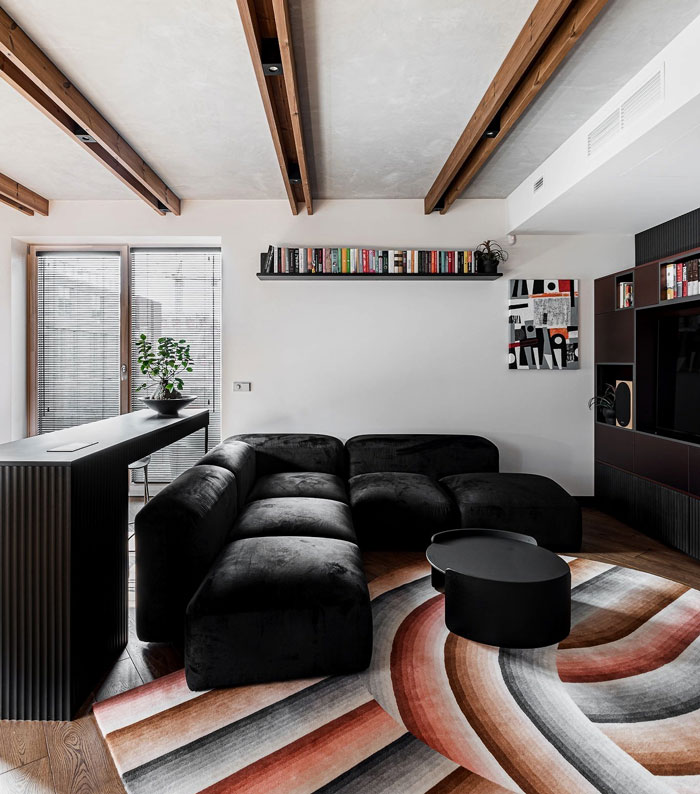 Avant-garde living room space with black couch