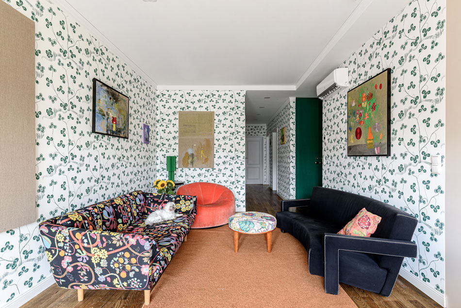 Eclectic living room with floral print sofa, patterned wallpaper, colorful furniture, and designer-inspired living room ideas. Eclectic living room with floral print sofa, patterned wallpaper, colorful furniture, and designer-inspired living room ideas.