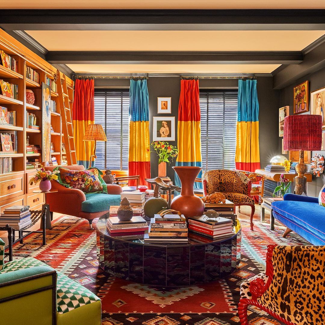 Maximalist colorful living room with round coffee table, vibrant curtains, patterned rugs, and eclectic furniture for interior ideas. Maximalist colorful living room with round coffee table, vibrant curtains, patterned rugs, and eclectic furniture for interior ideas.