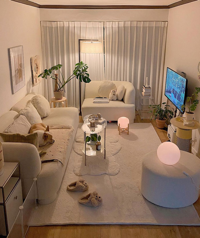 Cozy living room ideas featuring white walls, white couch, white carpet, plants, and warm lighting for interior refresh. Cozy living room ideas featuring white walls, white couch, white carpet, plants, and warm lighting for interior refresh.