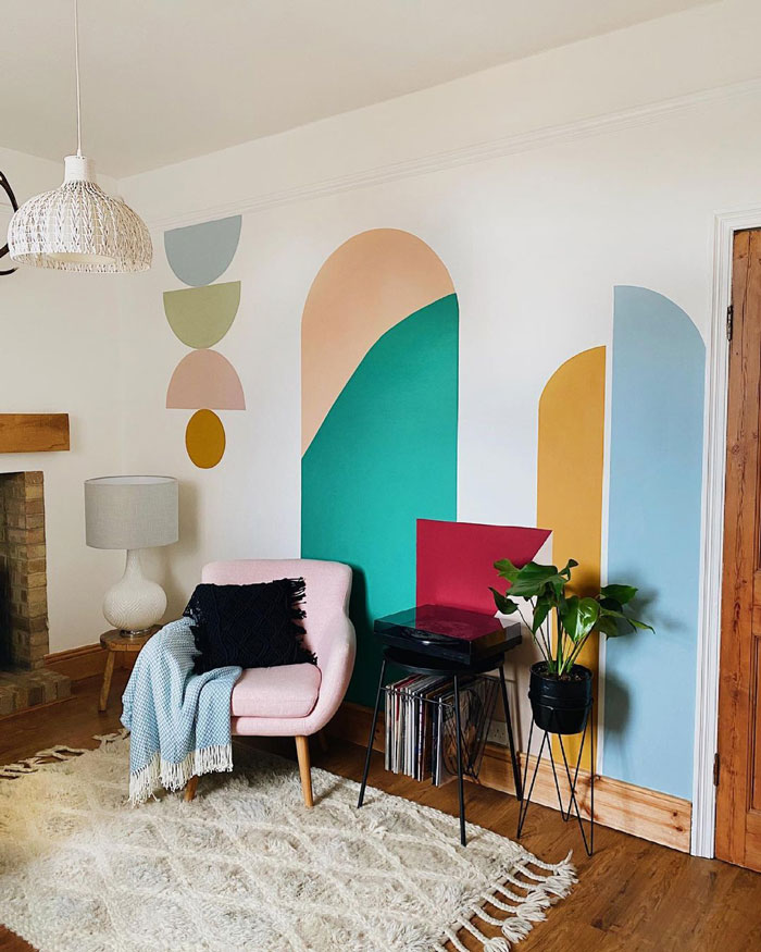 Living room ideas featuring painted wall decor, cozy chair, textured rug, and modern plant stand for stylish interior refresh. Living room ideas featuring painted wall decor, cozy chair, textured rug, and modern plant stand for stylish interior refresh.