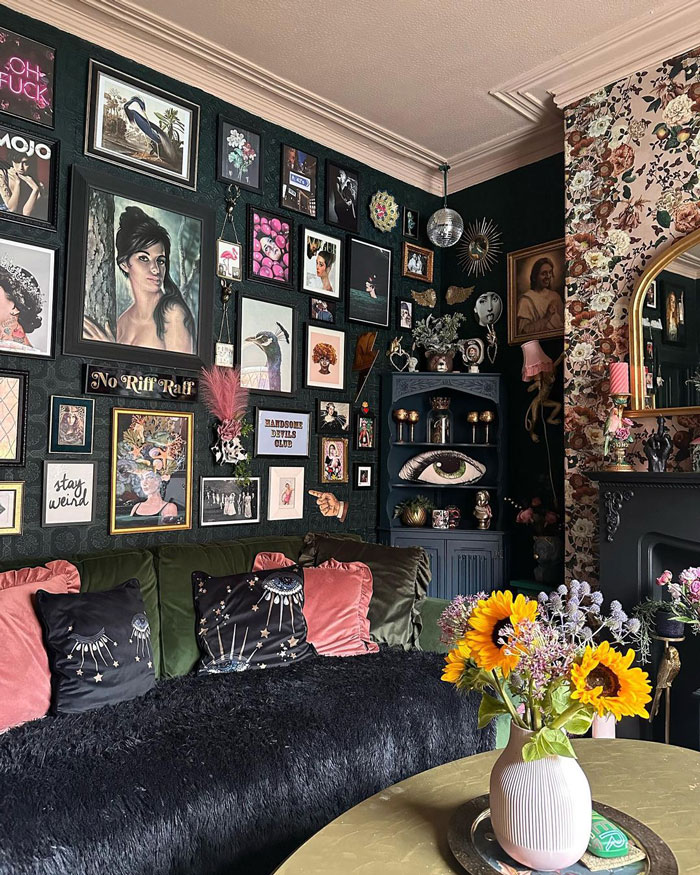 Black wall filled with eclectic wall art above a cozy sofa, featuring living room ideas and designer insights. Black wall filled with eclectic wall art above a cozy sofa, featuring living room ideas and designer insights.