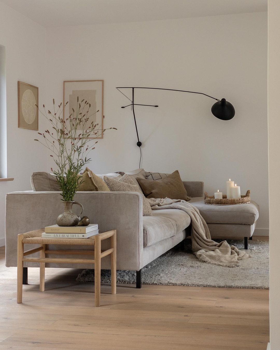 Scandinavian style living room with white walls, beige L-shaped couch, cozy pillows, and minimalist decor for interior refresh. Scandinavian style living room with white walls, beige L-shaped couch, cozy pillows, and minimalist decor for interior refresh.