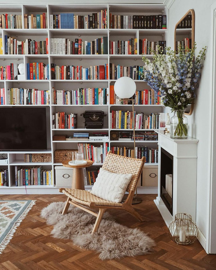 Living space with wall book shelf, fireplace and wooden chair