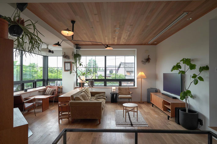 Simple living space with wooden ceiling and big windows