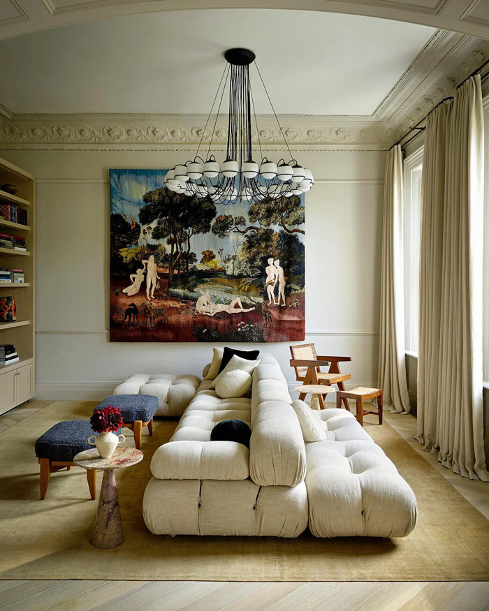 Classic style living space with big white couch and wall art