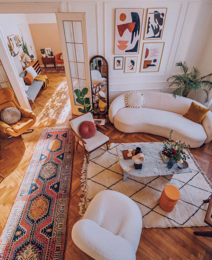 Living room ideas featuring a white couch, armchairs, graphic wall art, and stylish coffee table in a bright living space. Living room ideas featuring a white couch, armchairs, graphic wall art, and stylish coffee table in a bright living space.