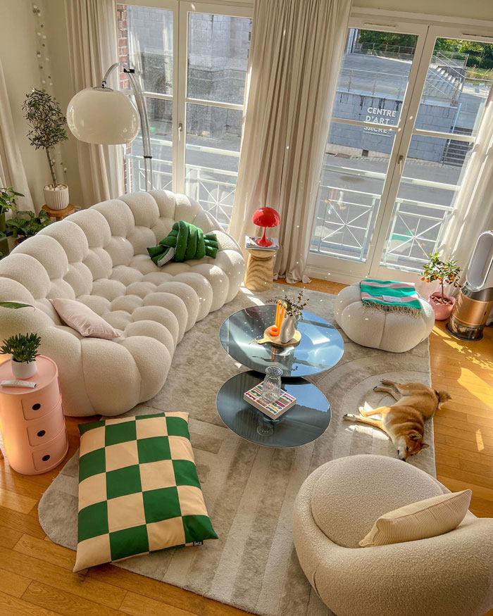 Cozy living room with white couch, large windows, modern furniture, and natural light for living room ideas and designer insights. Cozy living room with white couch, large windows, modern furniture, and natural light for living room ideas and designer insights.