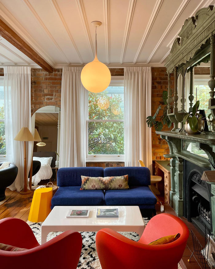 Cozy living room ideas with a blue couch, red armchairs, fireplace, and stylish interior design insights. Cozy living room ideas with a blue couch, red armchairs, fireplace, and stylish interior design insights.