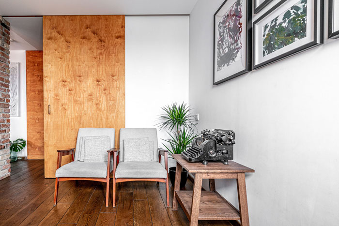 Living room ideas featuring two armchairs, wooden flooring, wall art, and decorative plants in a modern interior space. Living room ideas featuring two armchairs, wooden flooring, wall art, and decorative plants in a modern interior space.
