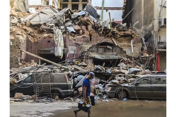 man-walks-past-explosion-site_1_600x400-64d264c7d90b6.jpg