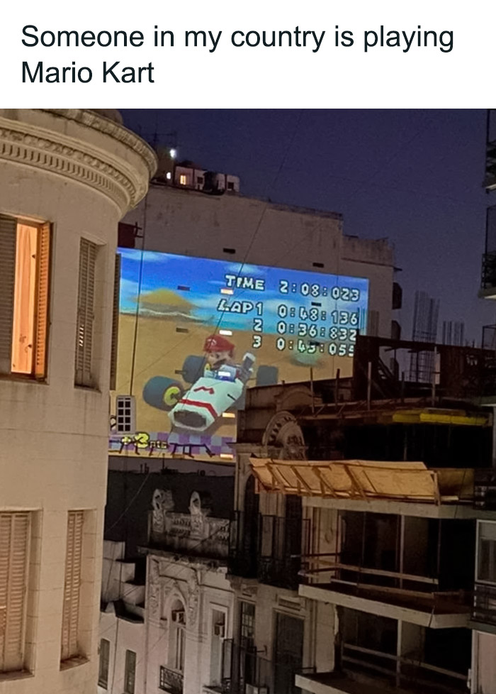 Someone is playing Mario Kart on the house wall through a wide-screen projector