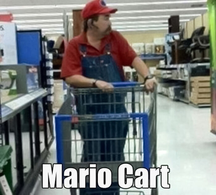 A man looks like Mario and pushes the cart in supermarket