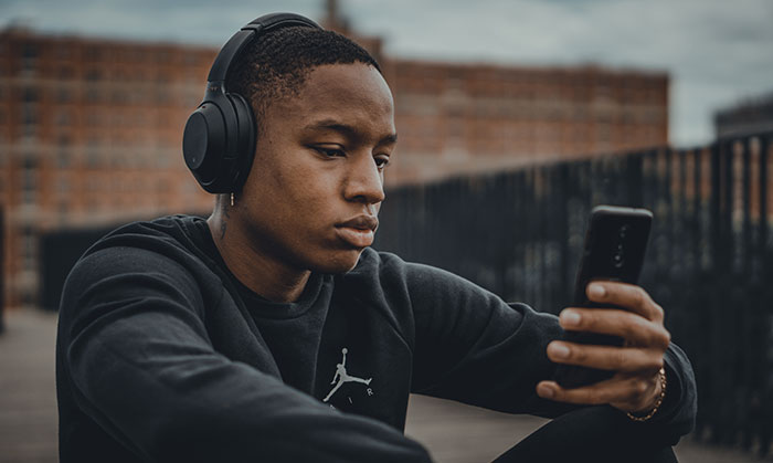 Man sitting watching phone and listening music