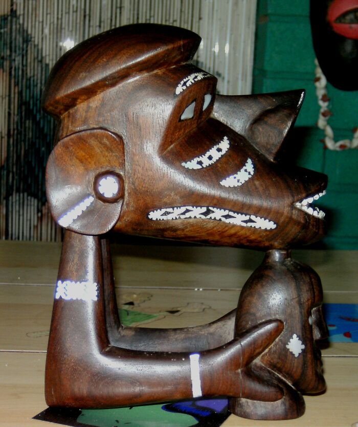 Solomon Islands Tiki - Nguzunguzu. Bought This From An Antique/Junk Shop In Hervey Bay Australia For $15. Nguzunguzu Is A Traditional Solomon Islands Carving Lashed To The Prow Of A Outrigger Canoe To Protect The Crew From The Water Spirit. Also Thought To Be Holding What The Crew Were On A Quest For, Sometimes Fish, This Example Holding A Head. Solomon Islanders Were Headhunters