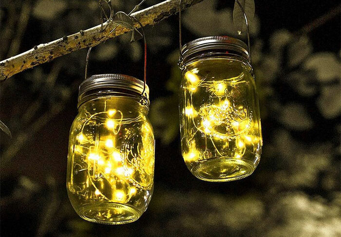 Mason jars with lights hanging on tree