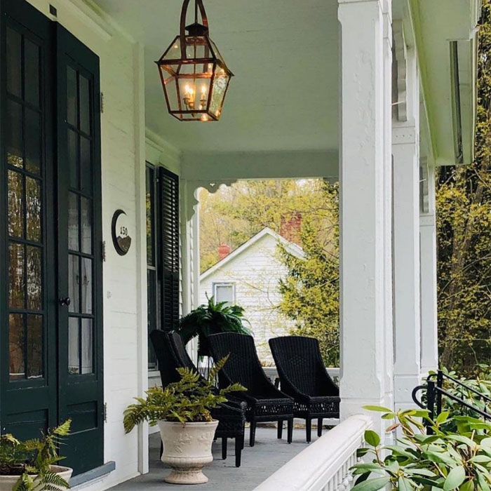 Porch with black furniture flowers and pendant light