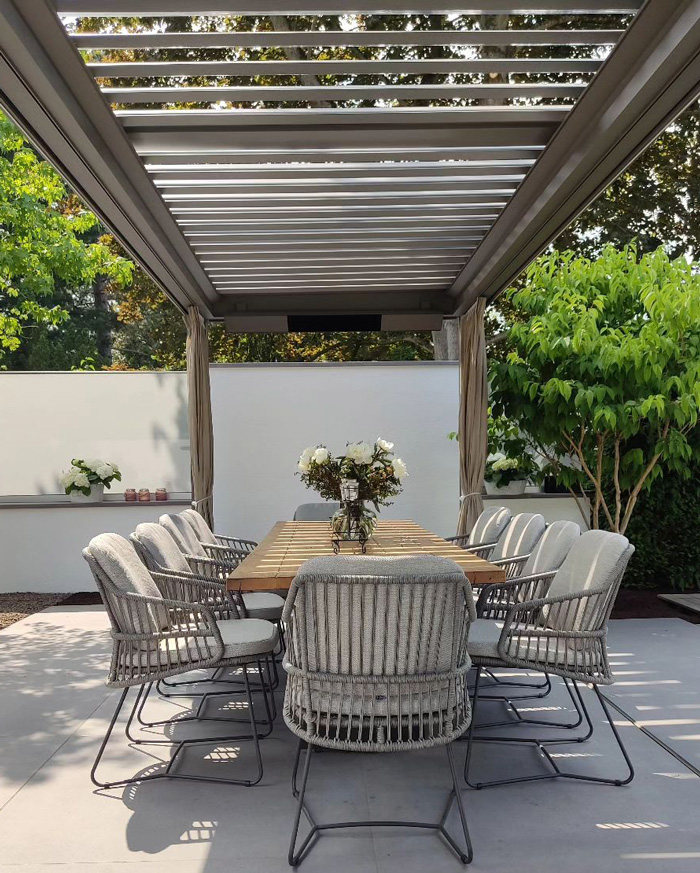 wooden pergola above dining table and chairs