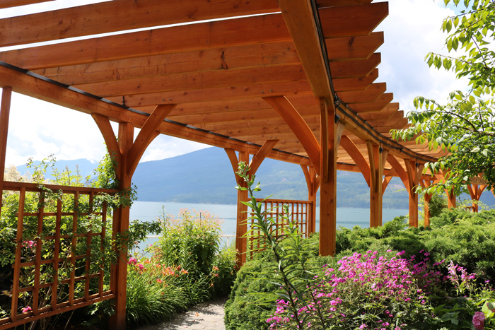 arching wooden walkway pergola surrounded by flowers