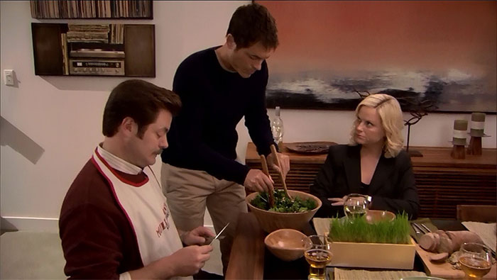 Ron Swanson and Leslie Knope waiting for the waiter to prepare the salad