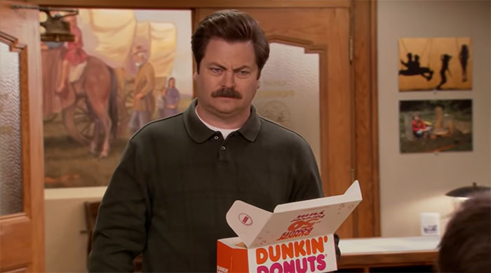 Ron Swanson holding a box of donuts